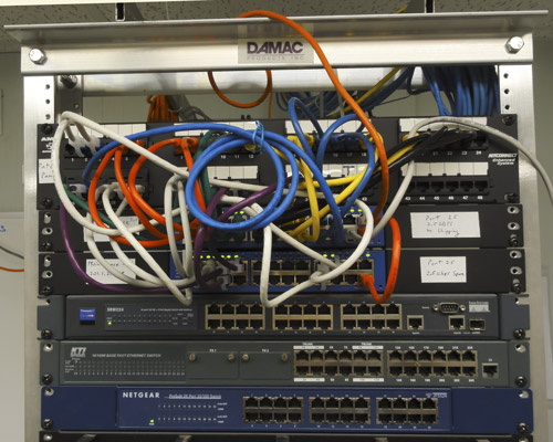 Relay rack with new switches and color-coded patch cords Photo of relay rack with new switches and color-coded patch cords